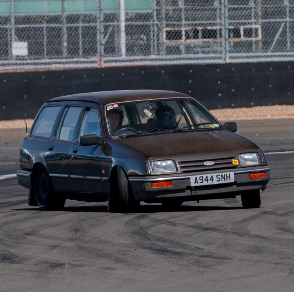 Brown Sierra estate going sideways on a race track